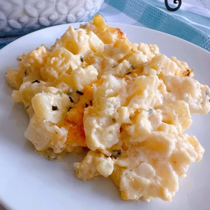 Best Cheesy Funeral Potatoes on a white serving plate.
