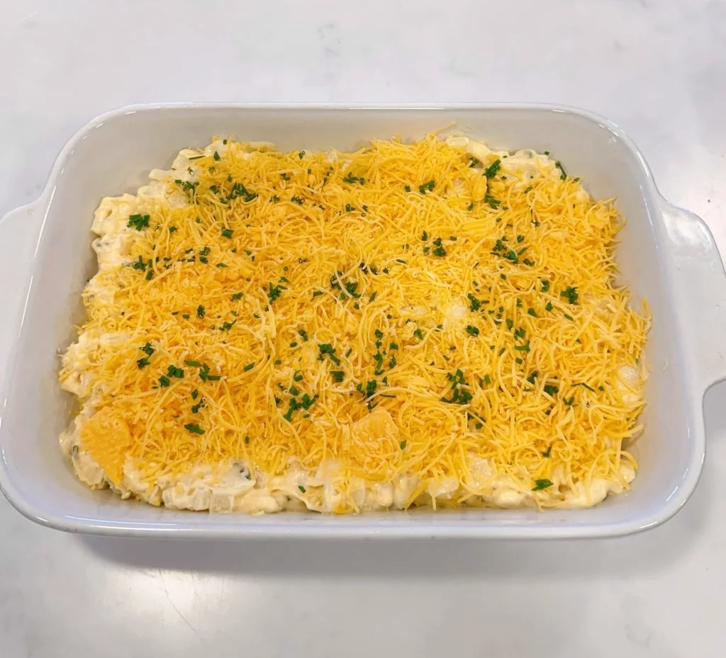 Funeral potatoes spread in a 9 x 13 baking dish ready to bake.