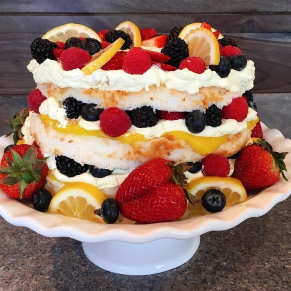 A layered angel food cake with berries and cream