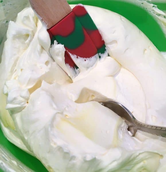 Folding Lemon Pudding and Whipped Cream together for filling and frosting