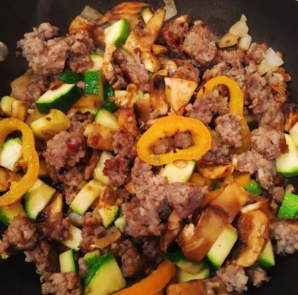 Omelet Filling sausage, peppers, and squash cooking in a skillet