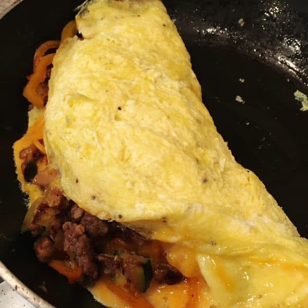 folding omelet over filling