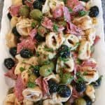 Tortellini Olive Salad on a beautiful white platter.