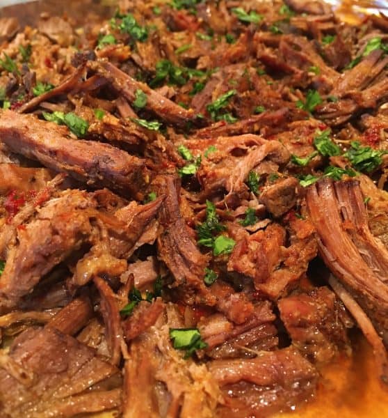 Beef Barbacoa shredded on a cookie sheet