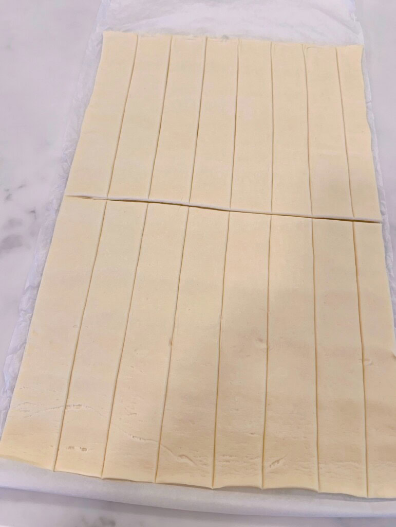 Puff pastry cut in half creating 16 individual strips.