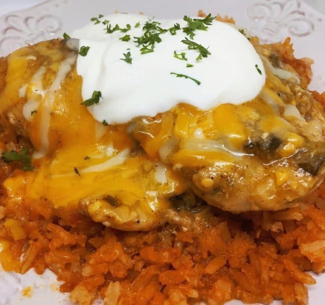 chicken verde topped with sour cream on top of rice