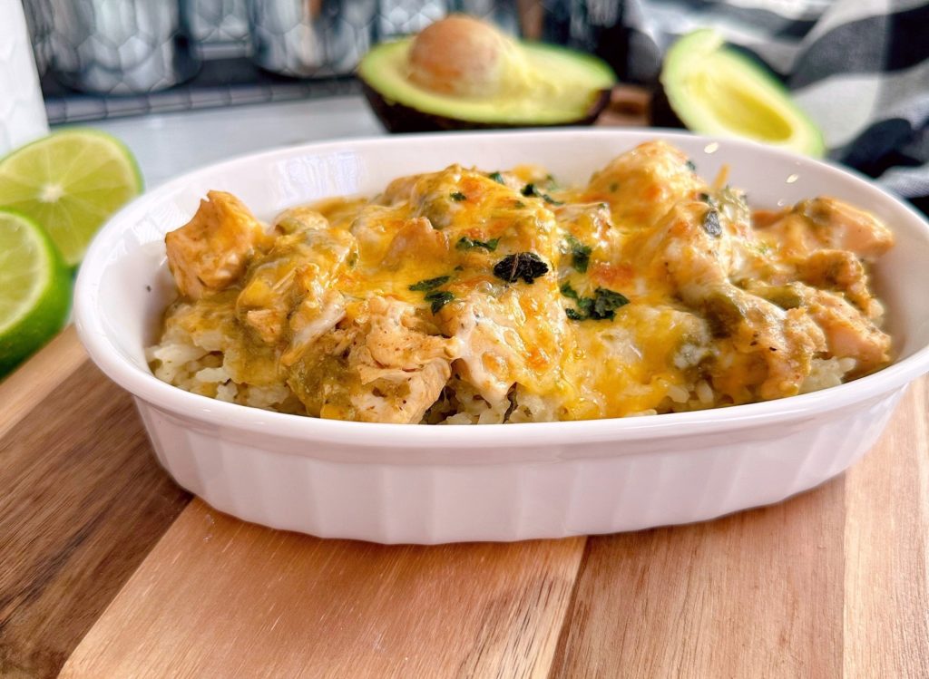 Close up of Chicken Chili Verde over rice in a white bowl.