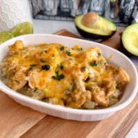 Chicken Chili Verde over rice in a serving bowl on a cutting board.