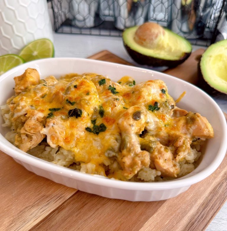 Chicken Chili Verde over rice in a serving bowl on a cutting board.