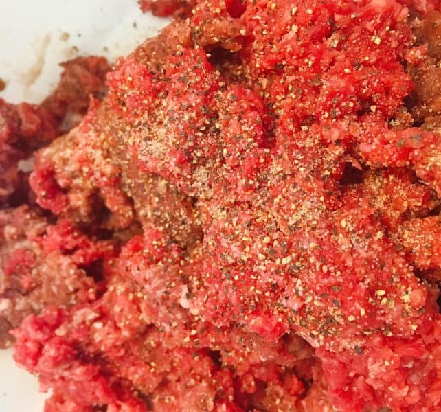 raw ground beef with seasonings for burgers