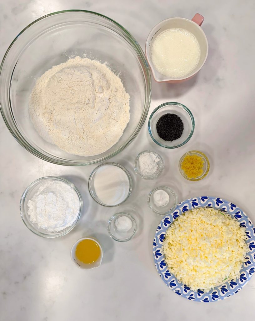 Ingredients for Lemon Poppy Seed Scones in bowls and on a counter top.