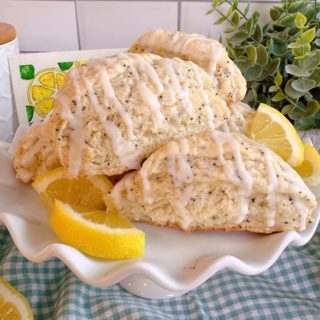 Lemon Poppy Seed Scones piled high on a mini cake plate.