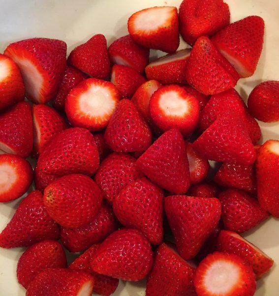 washed and prepared strawberries for pie filling
