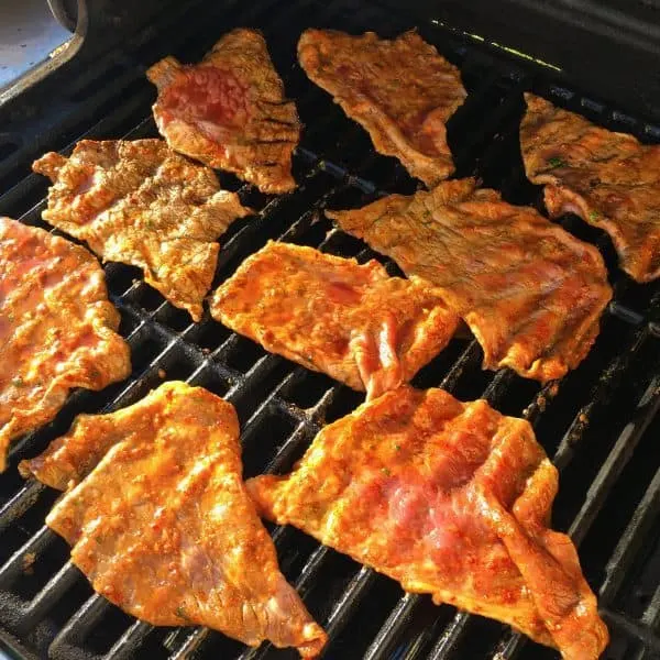grilling the carne asada