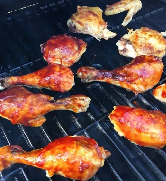 Chicken with BBQ sauce on the grill