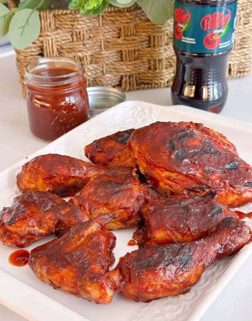 Grilledf Chicken with Cherry Dr Pepper BBQ sauce on a white platter.