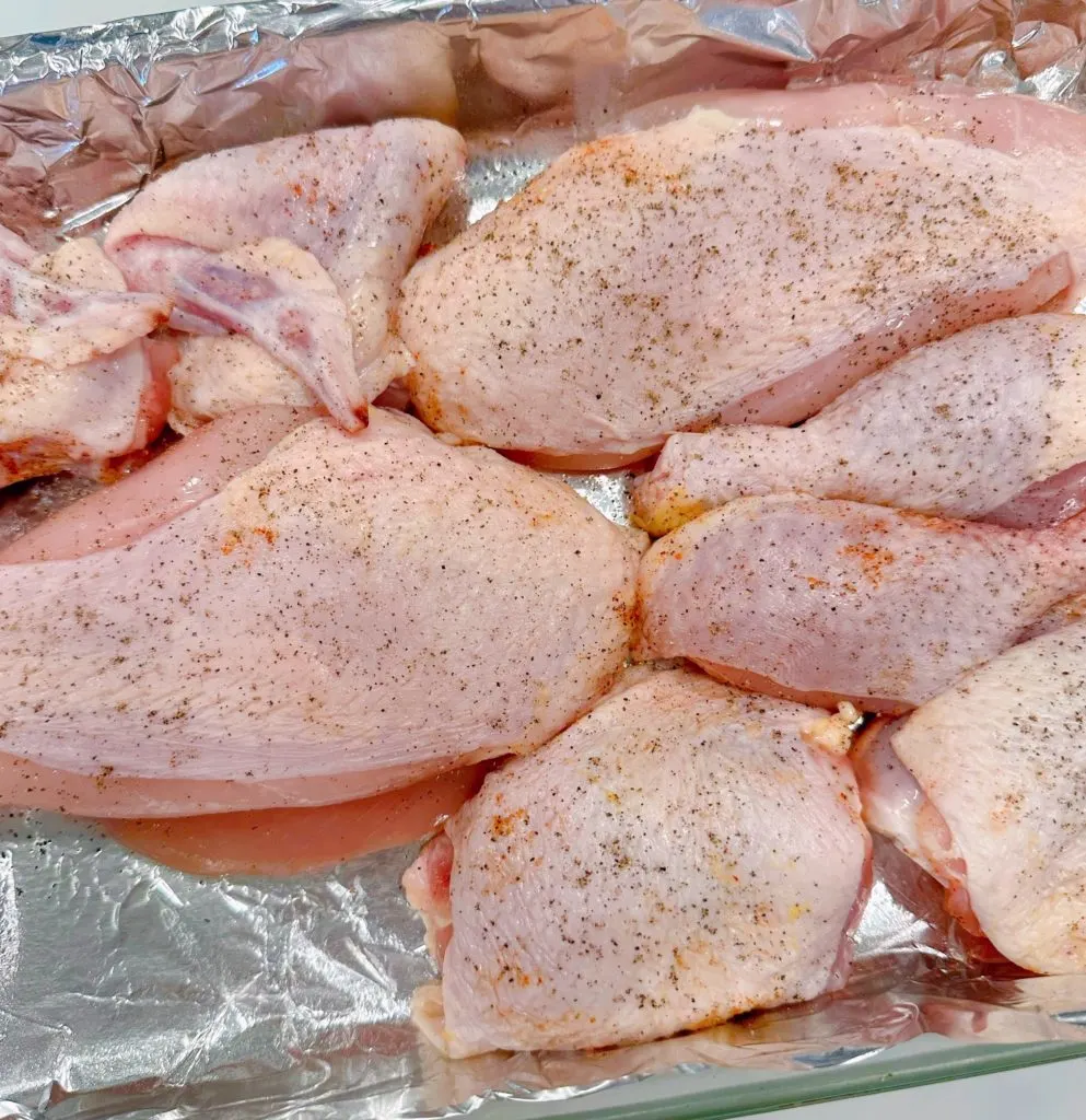 Chicken in baking dish with pepper.