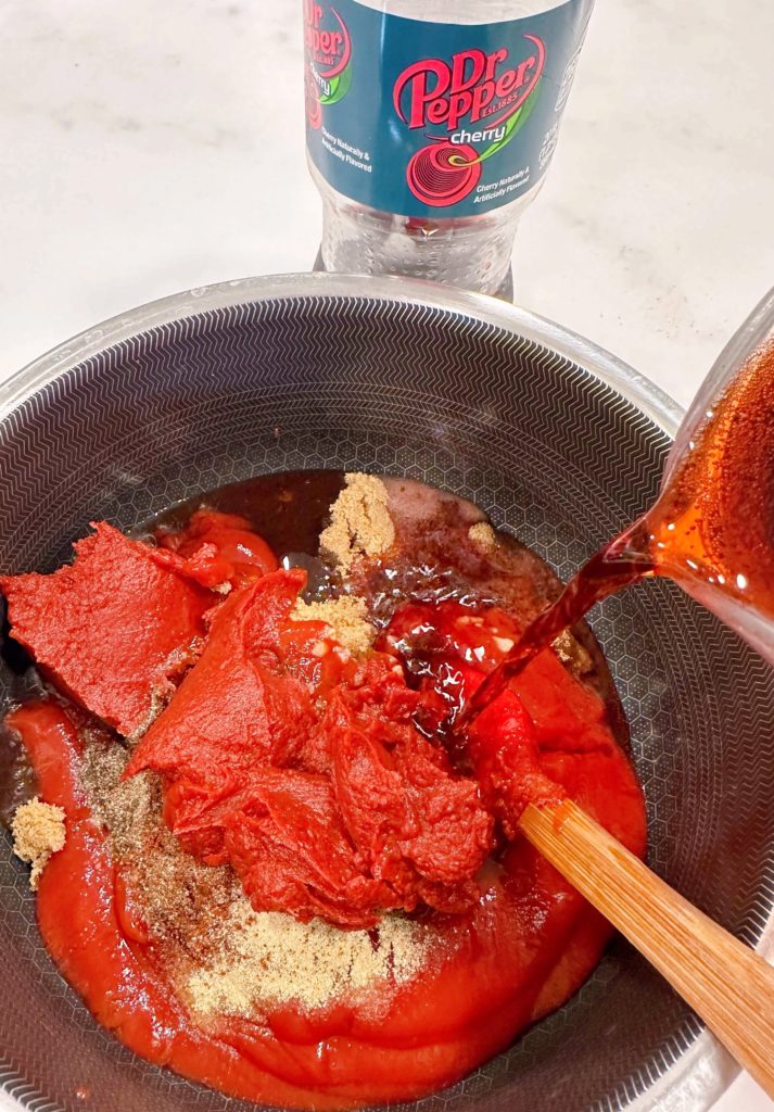 Ingredients for Cherry Dr Pepper BBQ sauce in a sauce pan.