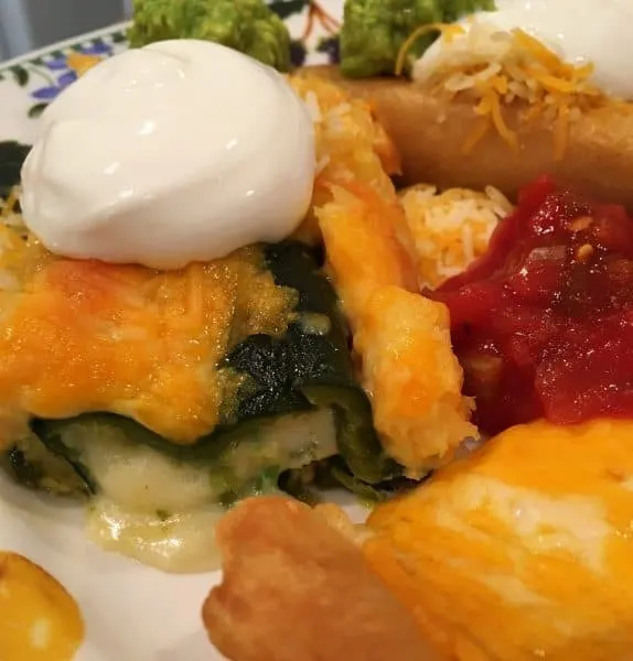 dinner plate loaded with chili relleno casserole and salsa