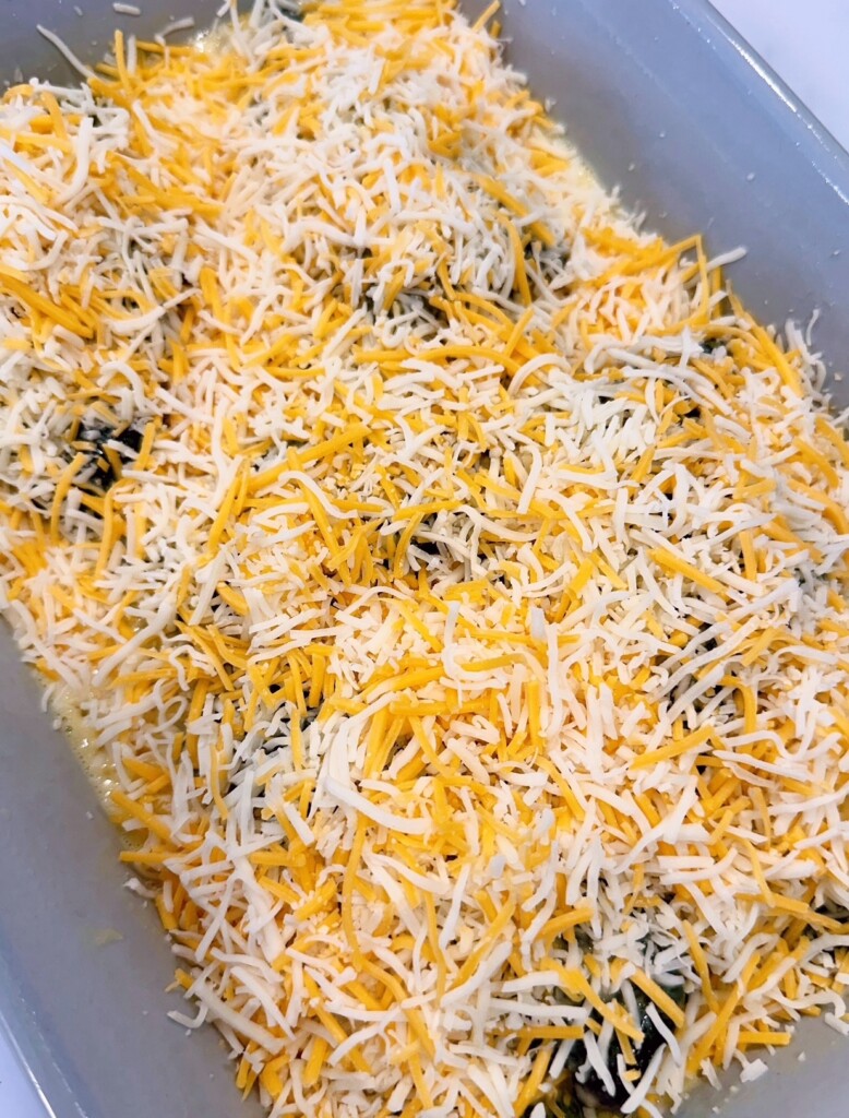 Peppers covered with batter and shredded cheese.