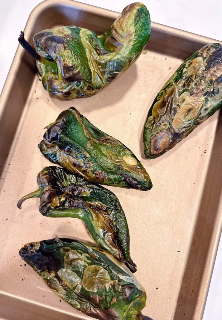 Pablano Peppers roasted on a baking sheet.