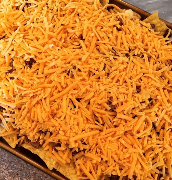 Grated cheddar cheese on top of meat 