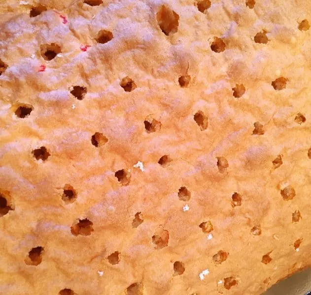 white cake poked with holes