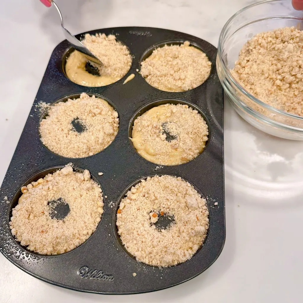 Sprinkle the top of each unbaked doughnut with crumb topping.