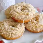 Crumb Baked Donuts piled high on a cake plate.