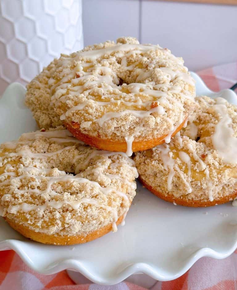 Crumb Baked Donuts piled high on a cake plate.