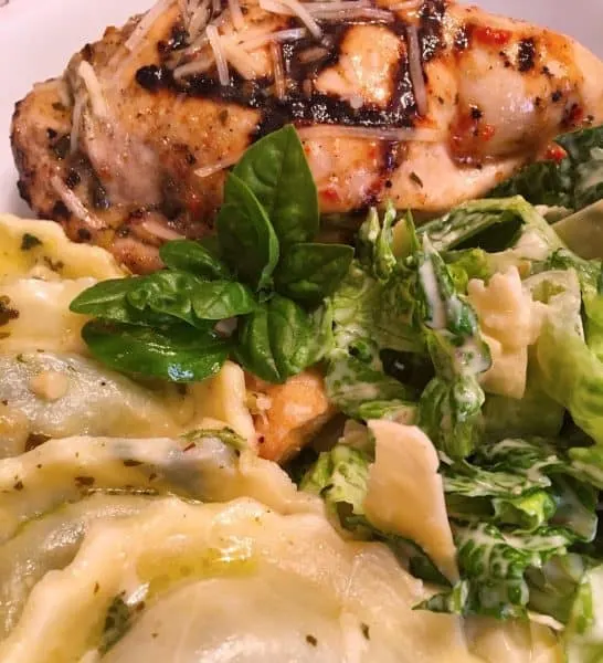 Stuffed Pesto Chicken Breast with salad and pasta