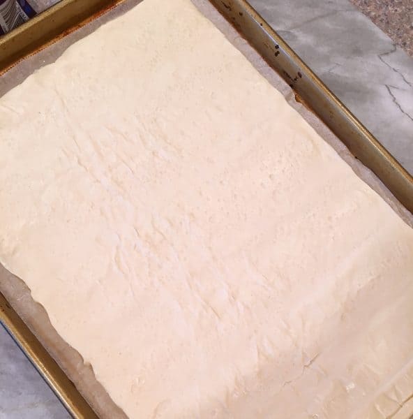Pizza crust on a baking sheet