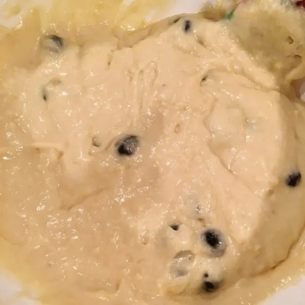 folding blueberries into batter