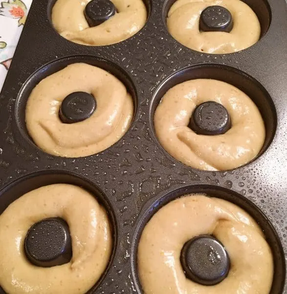 piped dough into donut baking pan