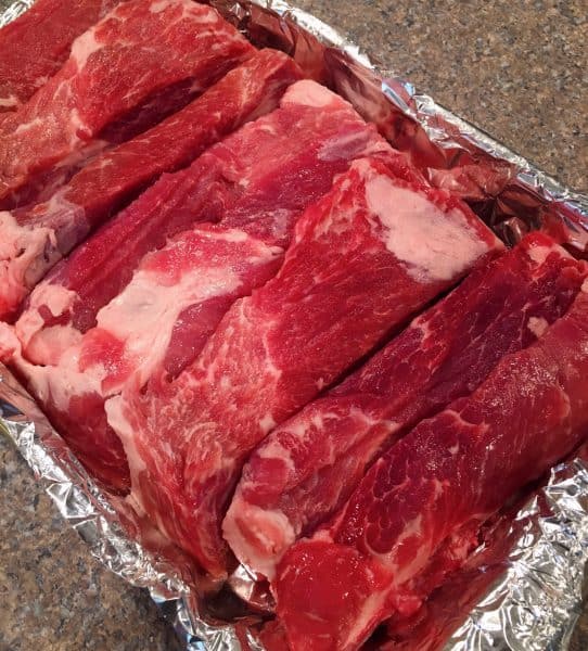 Country pork ribs in a lined casserole dish 