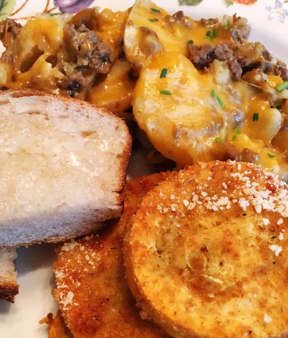 Dinner plate with Country Hamburger Skillet, sliced bread and oven fried squash.