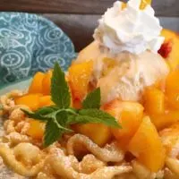 Funnel cake with peaches and cream