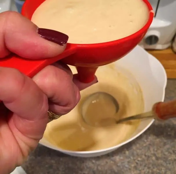 Using a funnel to make funnel cakes