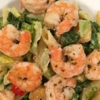A cesar salad with shrimp