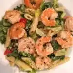 Shrimp Pasta Caesar Salad in a white salad bowl.