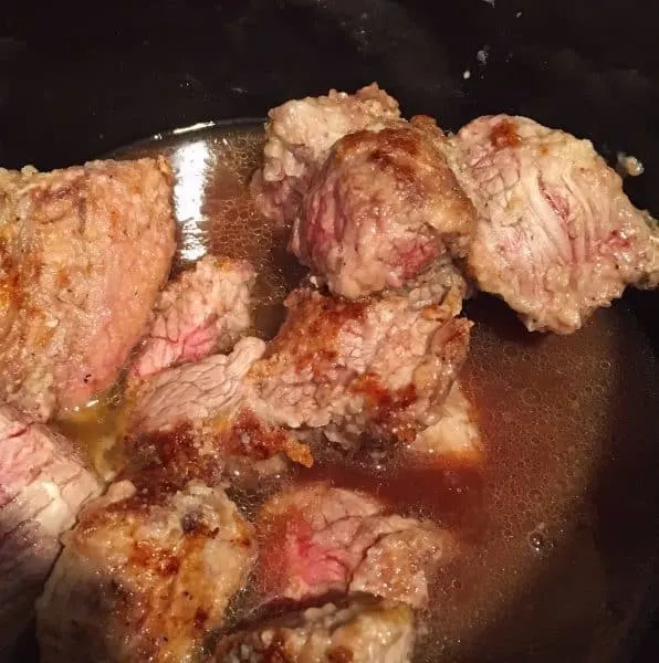 adding brown beef with beef broth