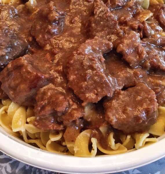 Beef and gravy over Parmesan Egg Noodles