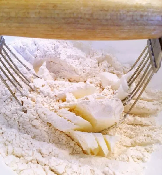 cutting shortening into flour for crust