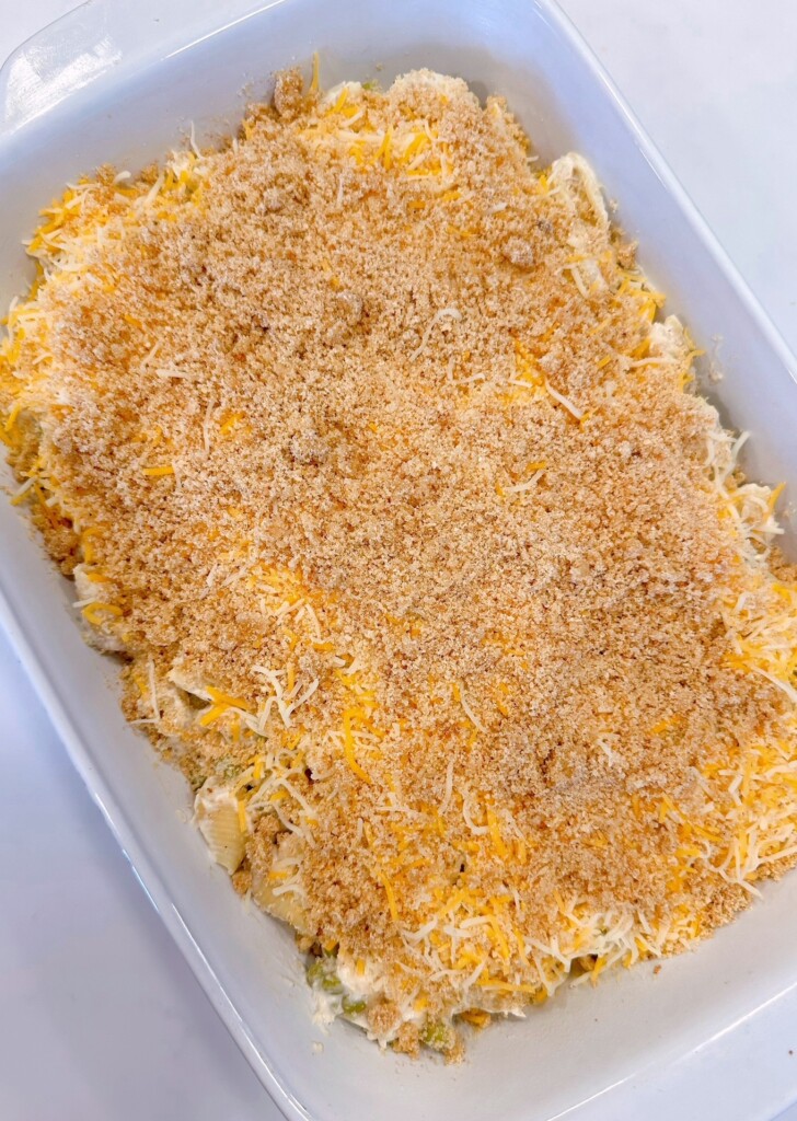 Casserole topped with cheese and prepared breadcrumbs.