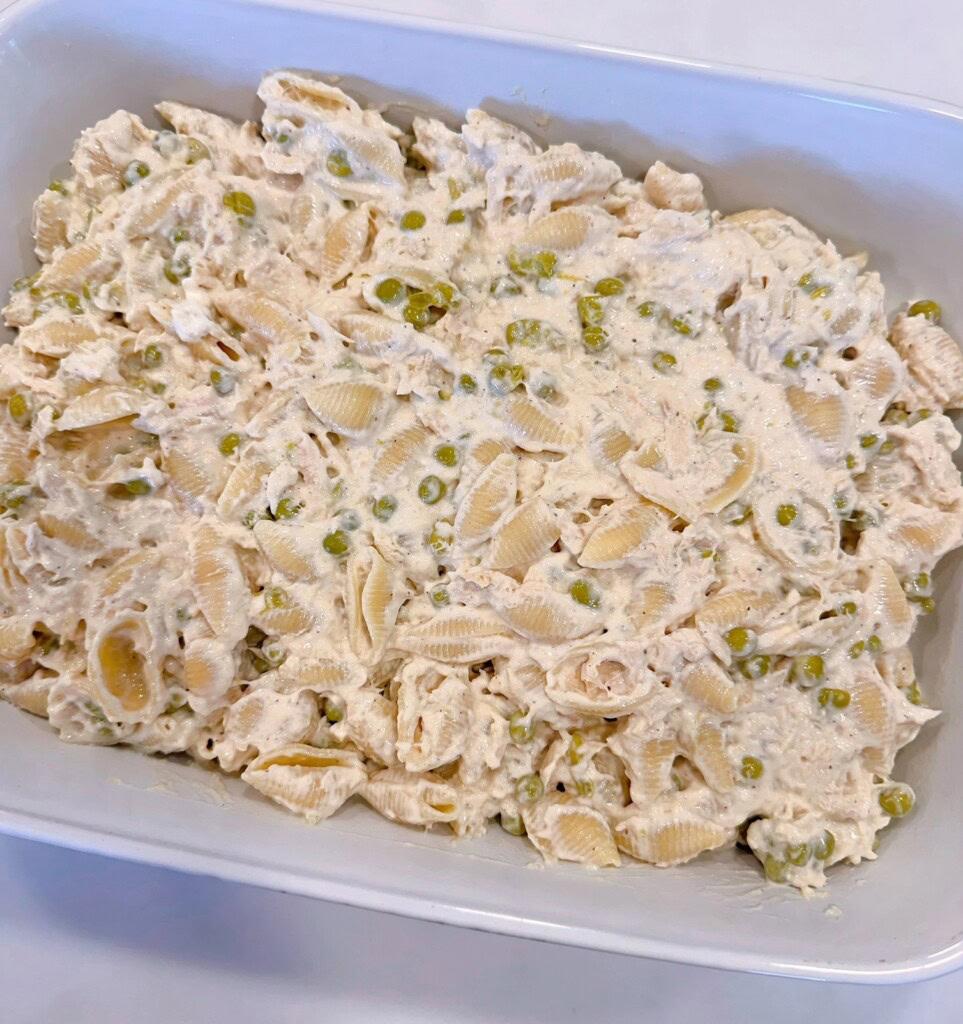 Tuna casserole spread out evenly in the baking dish.
