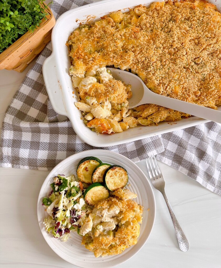 Baked Tuna Noodle Casserole in the baking dish and a plate filled with the casserole and side dishes.