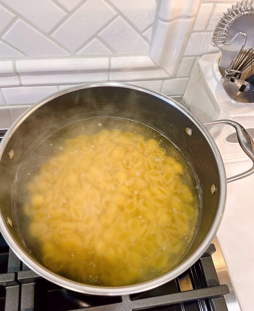 Pasta cooking in a large pot on the stove.