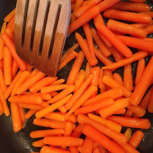 Baby carrots in butter in skillet