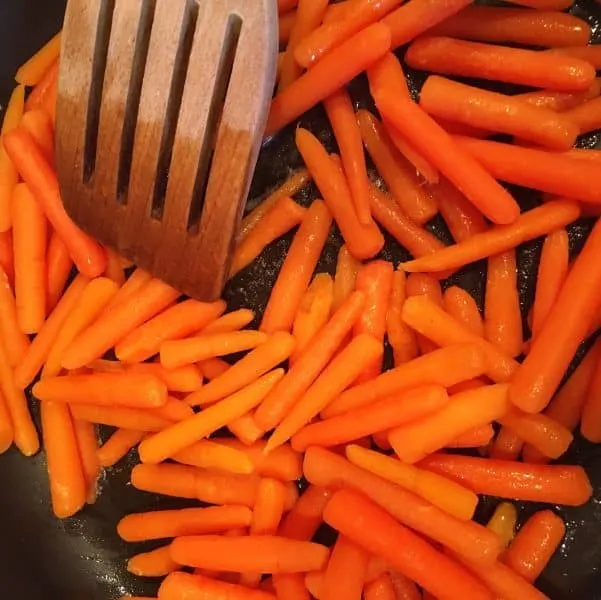 Baby carrots in butter in skillet