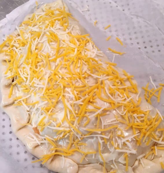 Top of pizza crust sprinkled with cheese